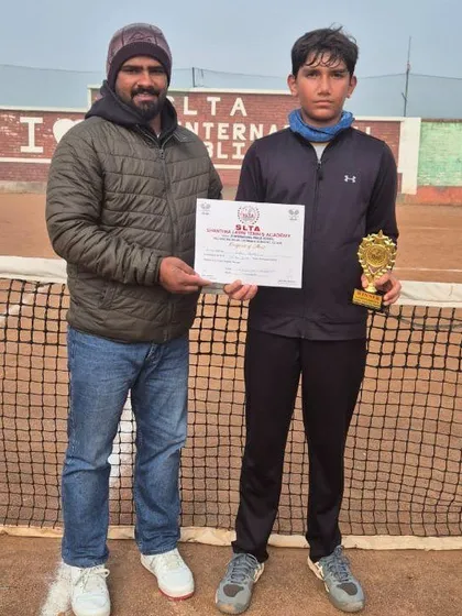 Anay Pandey with his coach, holding his certificate and trophy from the CS7 Tournament in Sonipat.