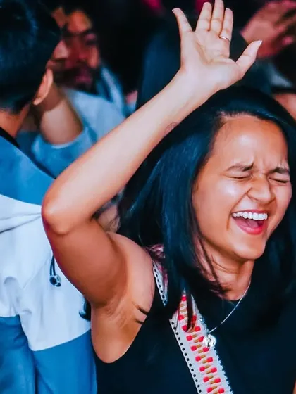 Did you say Fri-Yaaaayy with Fikticious? A shot of a guest laughing and dancing, the epitome of weekend joy.