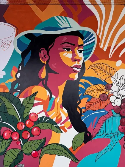 A close-up of the woman in the coffee mural, showing the pop-art influence and the rich, layered colors that make the artwork so eye-catching.