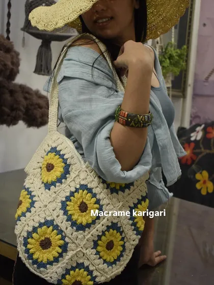 A different angle of the sunflower crochet tote, showing how comfortably it sits on the shoulder. The colors are vibrant and perfect for summer.