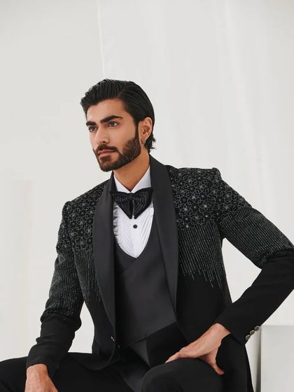 A relaxed yet elegant pose, showcasing the tuxedo's versatility and stylish appeal.