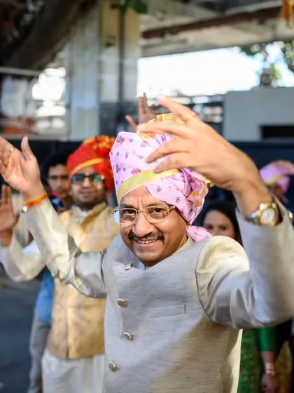 Even the parents get in on the baraat action. The father of the groom is all smiles as he dances his heart out.