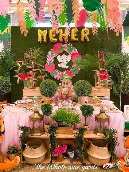 A "Wild, free & three" safari party for a little jungle explorer. The dessert table was surrounded by plush safari animals and lush greenery to create a friendly and adventurous jungle scene.