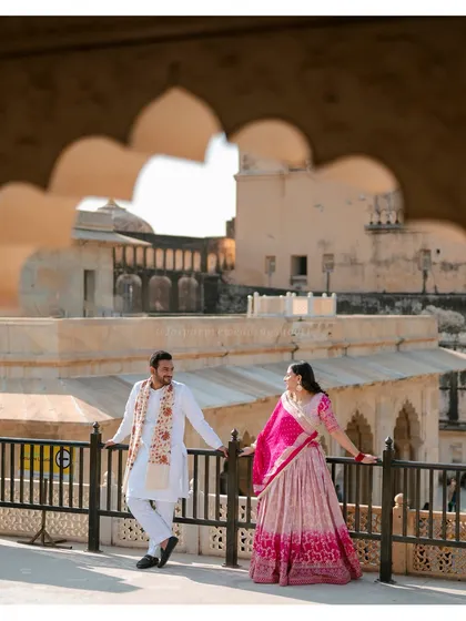 A candid shot of Ronit and Ritu enjoying the view from the ramparts of Amer Fort, with the surrounding Aravalli hills in the background.