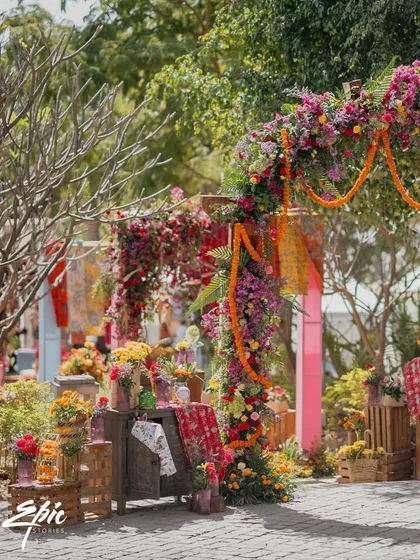Another angle of the vibrant entrance, showcasing the layers of flowers and textiles.