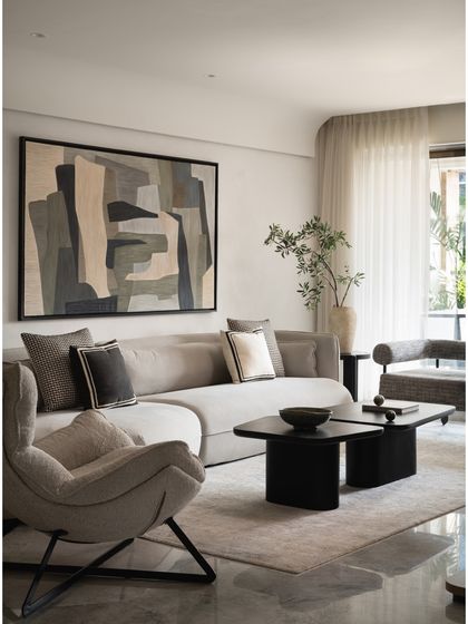 Another angle of the spacious living room, highlighting the large monochrome artwork that serves as a powerful focal point, tying the entire color scheme together.