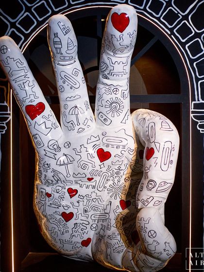 A large-scale hand sculpture covered in Keith Haring-style doodles served as a major art installation in the pre-dining room. This piece showcases how I integrate bespoke art objects to make a space truly unique and memorable.