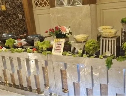 A fresh salad bar arranged on a modern, metallic buffet counter. The display is garnished with fresh lettuce and vegetables, emphasizing my commitment to fresh and healthy food.