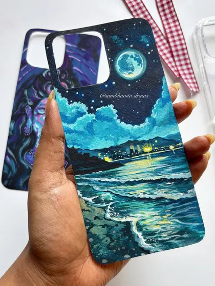 This custom-painted beach scene is one of my absolute favorites. I used acrylics on black paper to capture the glow of the city lights on the water, creating a moody and beautiful piece of art that you can carry with you.