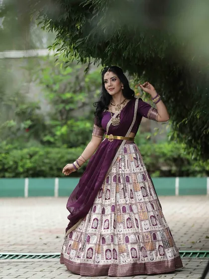 A dynamic shot of the model in motion, showing the beautiful flow and design of her traditional printed lehenga.