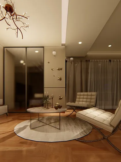 A view of the bedroom's lounge area, featuring classic Barcelona chairs and a marble-topped coffee table. The mirrored wardrobe doors and sheer curtains add to the sense of space and light.