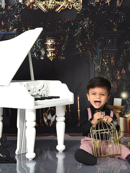 A moment of pure joy and laughter during our piano-themed session. It's these candid shots that truly capture a child's spirit.