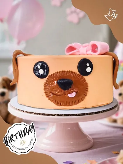 An adorable puppy cake with big, sweet eyes and a pink bow. This cake is sure to melt the hearts of any dog lover.
