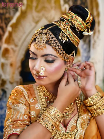 This detailed shot shows the intricate work on the hairpiece and earrings, essential components of a complete bridal look.