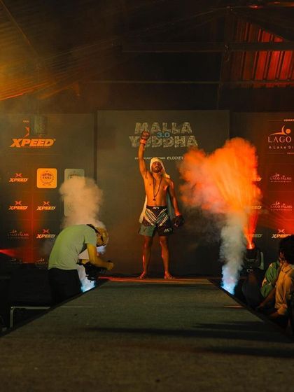 A warrior's entrance at a Mallayuddha MMA event. The walk to the cage is a mental game, and our fighters are prepared to own the stage from the moment they step out.