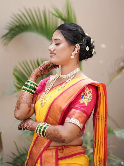 A graceful bridal portrait, highlighting her elegant hairstyle and the details of her saree.
