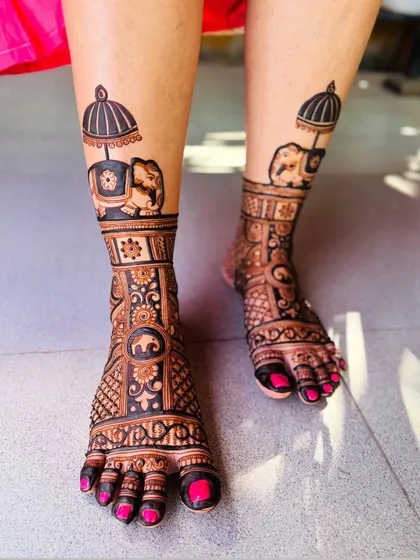An elegant foot design featuring a decorated elephant under a royal umbrella.