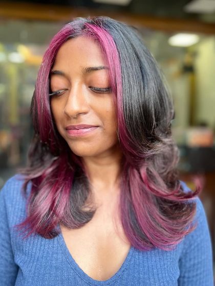 A close-up of the finished purple peekaboo highlights. The color is strategically placed to peek through the darker base hair, creating a fun and surprising effect when the hair moves.