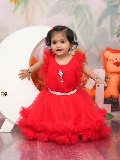 A full shot of the jungle moon theme, with the little girl posing happily. The "ONE" blocks and stuffed animals make this a perfect first birthday celebration.