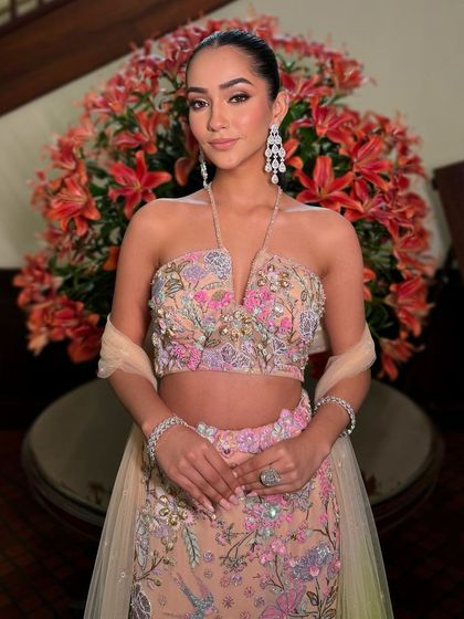 A front-on view of this modern chic look, highlighting the flawless skin and the way the makeup enhances the client's natural beauty.