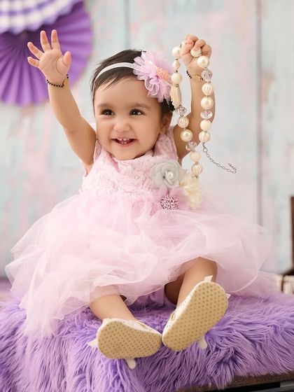 Pretty in pink and purple. We coordinate outfits and backdrops to create visually beautiful portraits that highlight your baby's charm.
