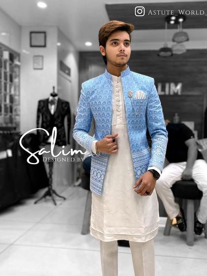 A client in a light blue Indo-Western jacket with a white geometric pattern. This fresh and stylish look is perfect for daytime events.