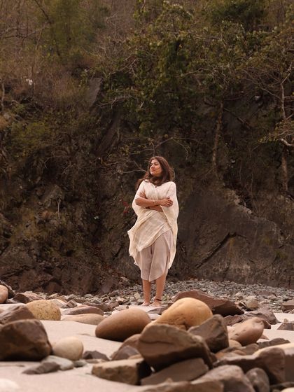 A moment of quiet contemplation by the river. The serene landscape of Rishikesh provides the perfect backdrop for turning inwards and finding a sense of peace.
