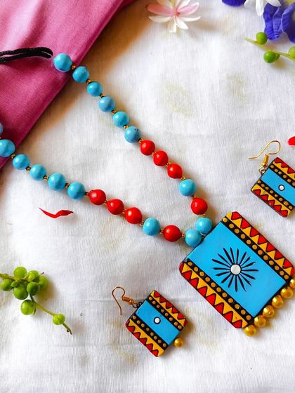 A cool blue and red version of the square pendant necklace, perfect for adding a subtle pop of color.