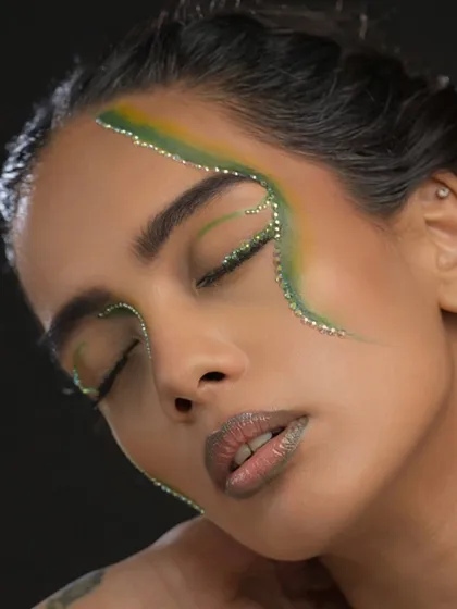 An abstract editorial look featuring green and yellow pigments with delicate rhinestone detailing along the graphic lines.