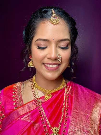 A close-up of the eye makeup. I used soft, neutral tones with a hint of shimmer to make her eyes sparkle, complementing her pink saree beautifully.