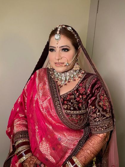 A side profile of Juhi's stunning wedding look. You can see the perfect draping of her dupatta and the way the makeup enhances her features beautifully.