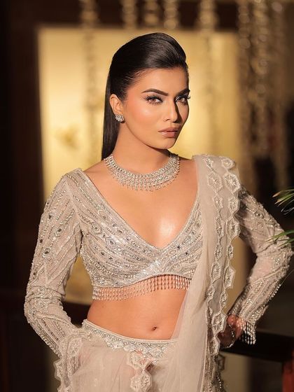 A full-length view of this stunning silver-grey lehenga. The intricate beadwork and modern blouse design make it a perfect choice for a contemporary reception or engagement party.