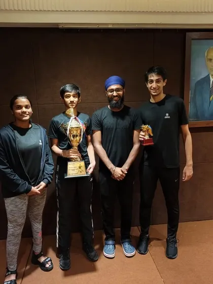 Our district champions Harshit, Sahil, Devanshi, and Sanjeevani with their coach after a successful tournament.