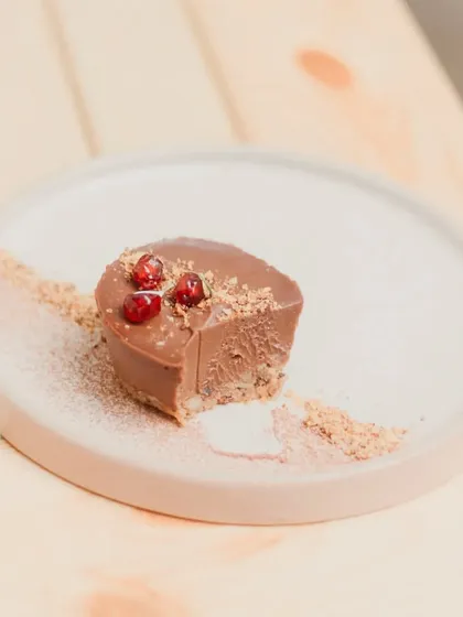 A bite taken out of our Mocha cheesecake, revealing its creamy texture.