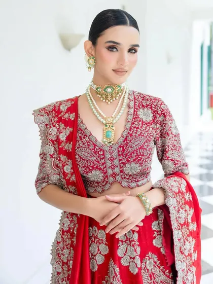 A full view of the Jayanti Reddy lehenga, showcasing the balance between the detailed silver embroidery and the rich red fabric. My focus was on a powerful yet graceful silhouette.