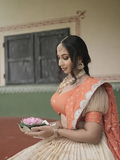 This was for a creative Navratri-themed shoot. I designed a traditional yet artistic look with soft, glowing skin and defined eyes to match the divine and elegant theme, complete with traditional jewelry and a serene expression.