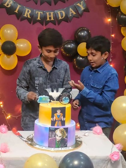 A cool fusion cake for an older kid, combining the worlds of Joker and Naruto. This two-tiered cake features edible images of both characters, perfect for a fan of both series.