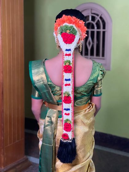 A unique and colorful take on the traditional bridal braid, using multi-colored floral arrangements to create a vibrant and festive look.
