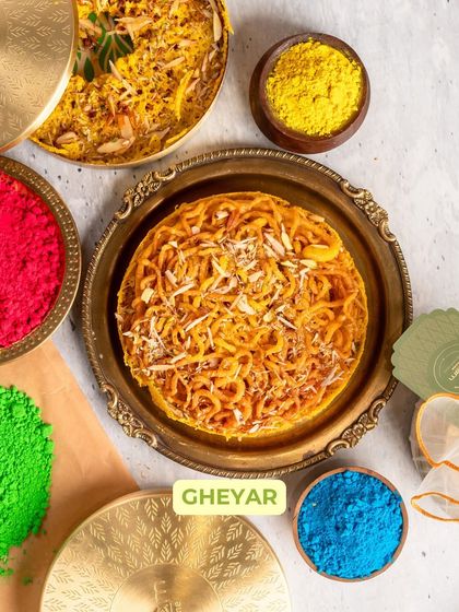 The star of my Holi collection, this Gheyar is a traditional Rajasthani sweet. Its intricate, web-like texture is soaked in syrup and garnished with nuts, making it a true festive indulgence.