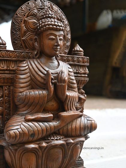A close-up of the 24-inch wax brown Buddha, focusing on the peaceful facial expression and the intricately carved hair.