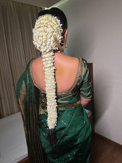 Another beautiful example of a South Indian bridal hairstyle, with a long braid completely covered in jasmine flowers. This look is both traditional and incredibly fragrant.