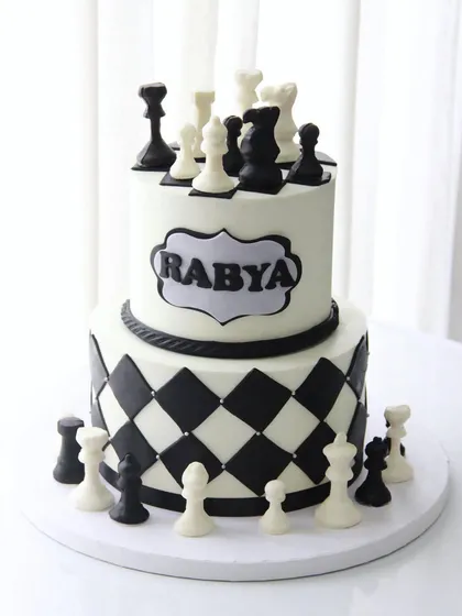 Checkmate! A stunning two-tiered chessboard cake where all the chess pieces are completely edible and made from chocolate.