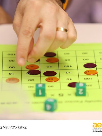 A close-up of a fact fluency game played by parents. These workshops are designed to be interactive, informative, and fun.