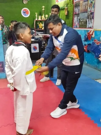 Awarding a yellow belt to my student. This is the first major step after the white belt.