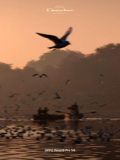 A beautiful, hazy sunrise at Yamuna Ghat, captured with the OPPO Reno13 Pro. This photo showcases the phone's ability to handle challenging light conditions and capture atmospheric scenes with a painterly quality.