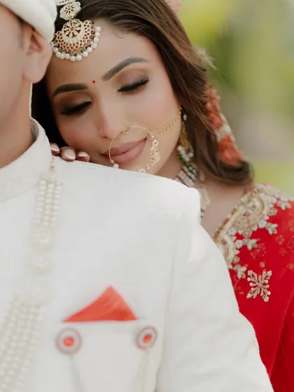 An incredibly tender and intimate moment. The bride rests her head on the groom's shoulder, her eyes closed in a state of peaceful love.