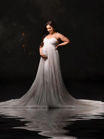 A stunning water-reflection shot of Palak Vij, adding an element of artistic elegance to her maternity photos.