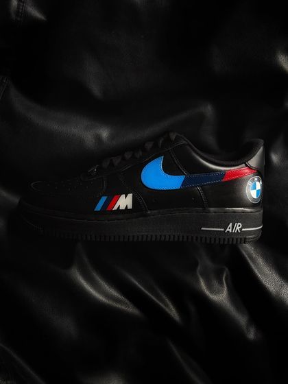 A custom black Nike Air Force 1 featuring the classic BMW M-series colors and logo.