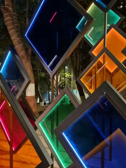 A close-up of the multi-colored, illuminated panels of the 'Family Tree'. The geometric design and vibrant colors create a dynamic visual effect that changes as you move around it.