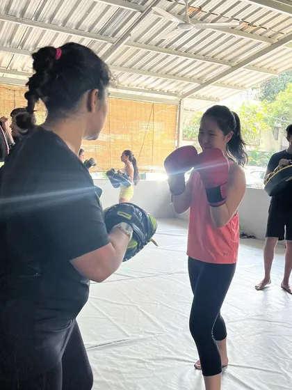A student gets some pad work in during our pizza party event. Earn your slice.